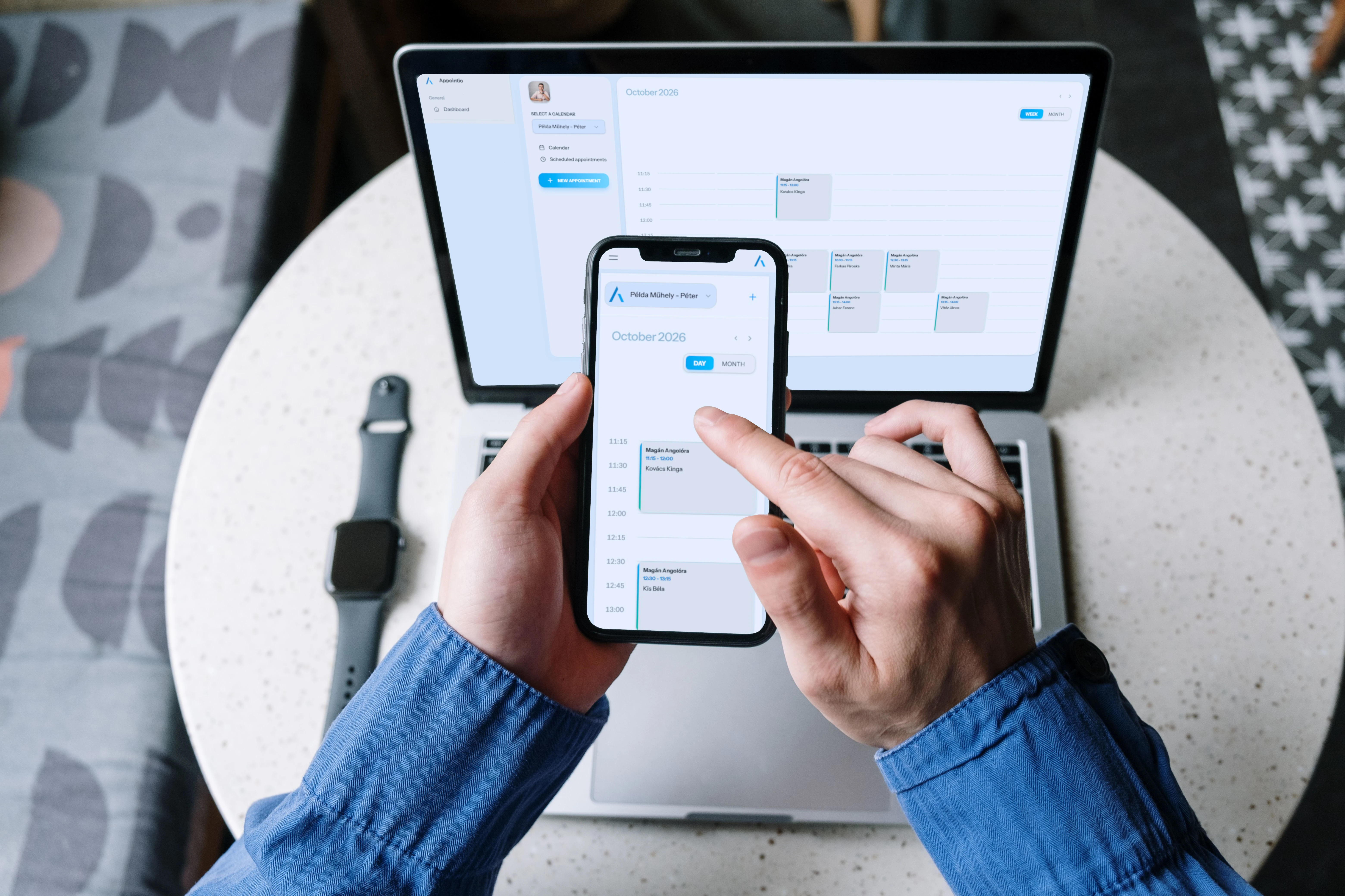 Hand holding a phone with the login page of appointio